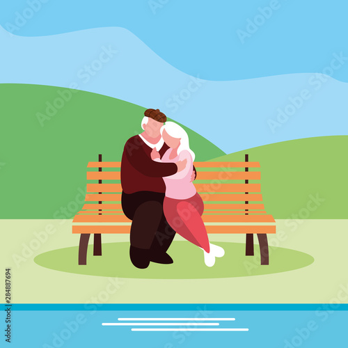 cute old couple seated in chair of park