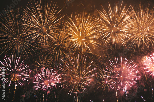 Yellow and red festive fireworks on a black background. Abstract holiday background. International Fireworks Festival ROSTEC