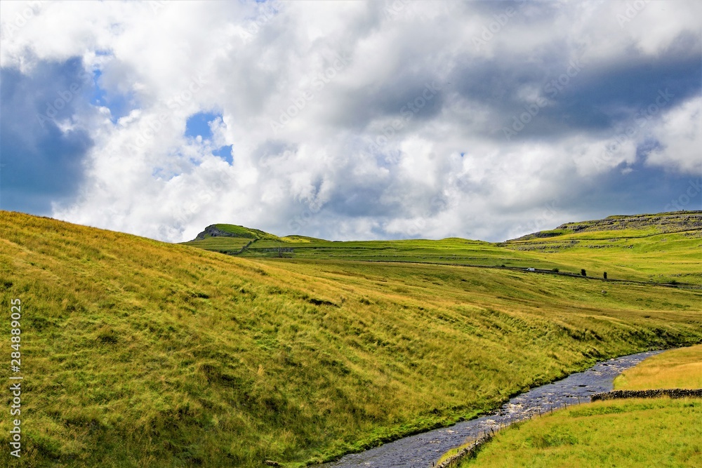 Naklejka premium Clouds gathering over Ingleton, in the Yorkshire Dales, on Saturday, 17th August, 2019.