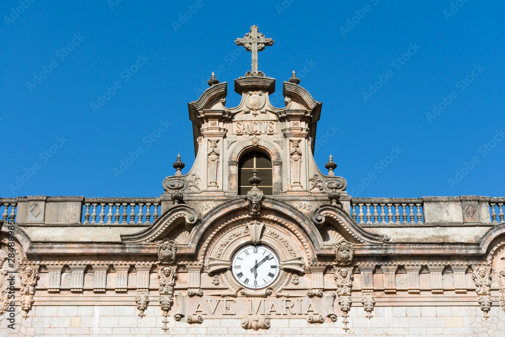 the clock on the building of the monastery of lluc in Mallorca