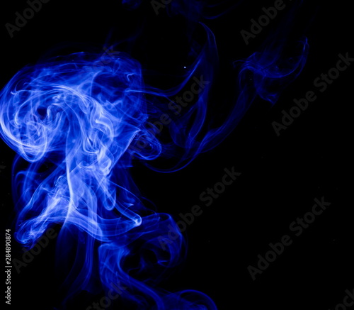 Blue smoke on black background