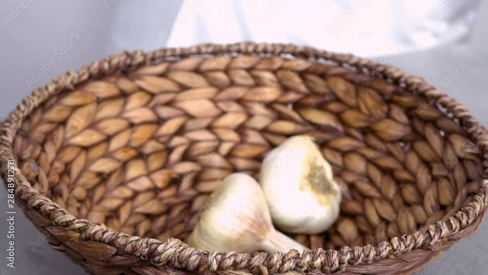Organic garlic heads in wicker basket. Organic garlic heads in wicker basket.