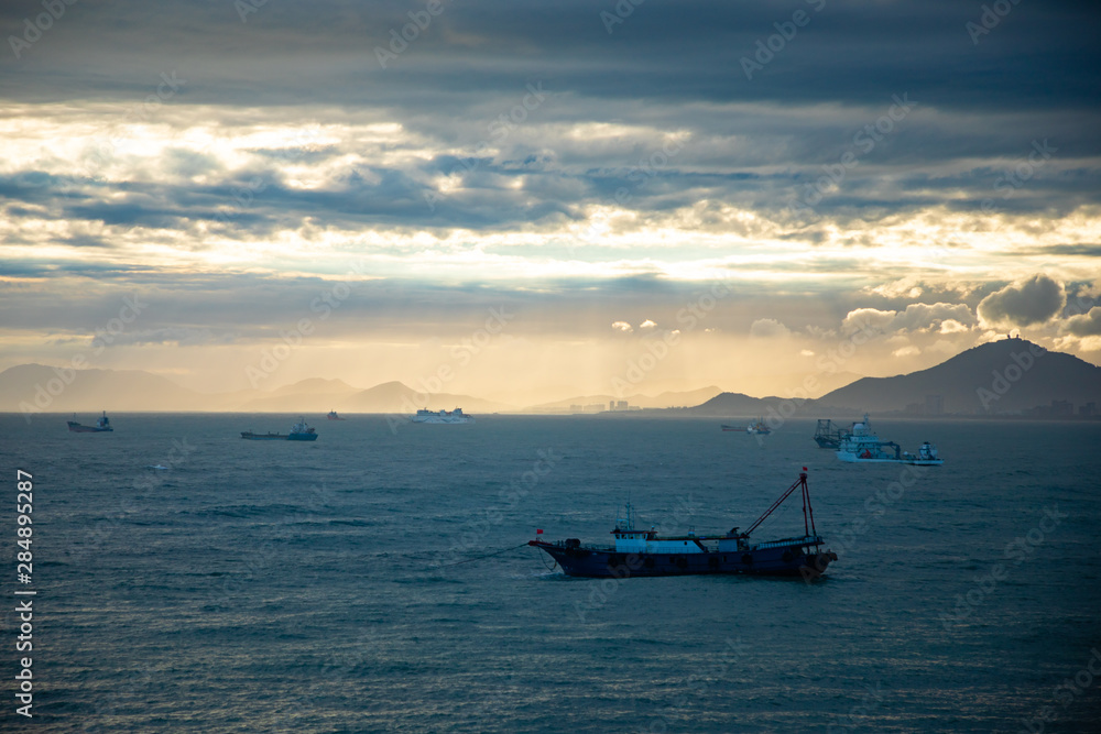 Fishing boat on sea in sunset lights in Sanya, Hainan, China