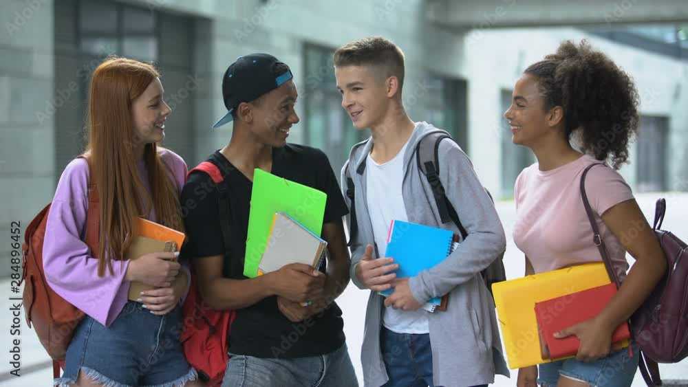 Group of multiethnic students laughing and telling funny stories, friendship Group of multiethnic students laughing and telling funny stories, friendship