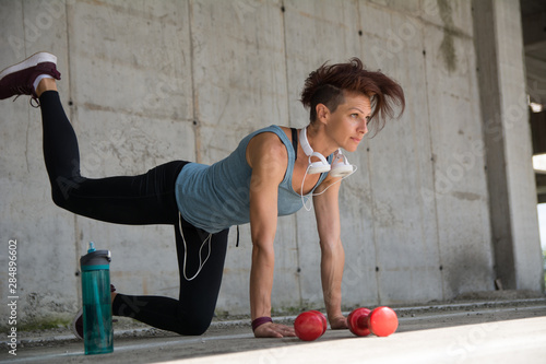 Wallpaper Mural Low angle shot of beautiful slim muscular woman doing stretching workout Torontodigital.ca