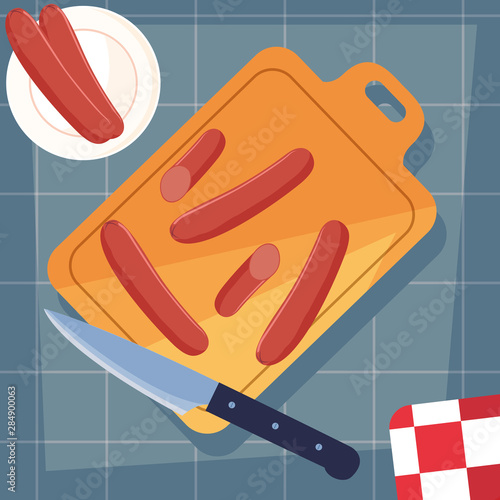 kitchen board with sausages and knife