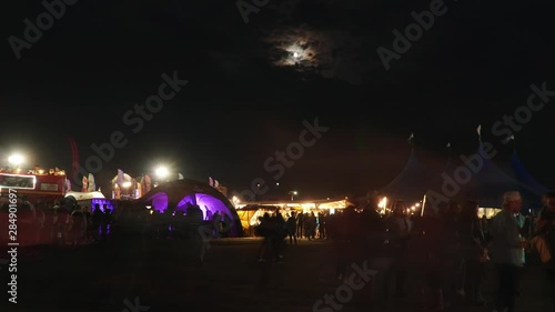 Music festival nightlife with moon and cloudy sky on background in Timelapse. 4k video