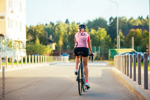 Picture of young woman in helmet on bike ride on summer day © nuclear_lily