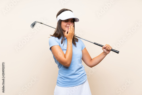 Young golfer woman over isolated background smiling a lot