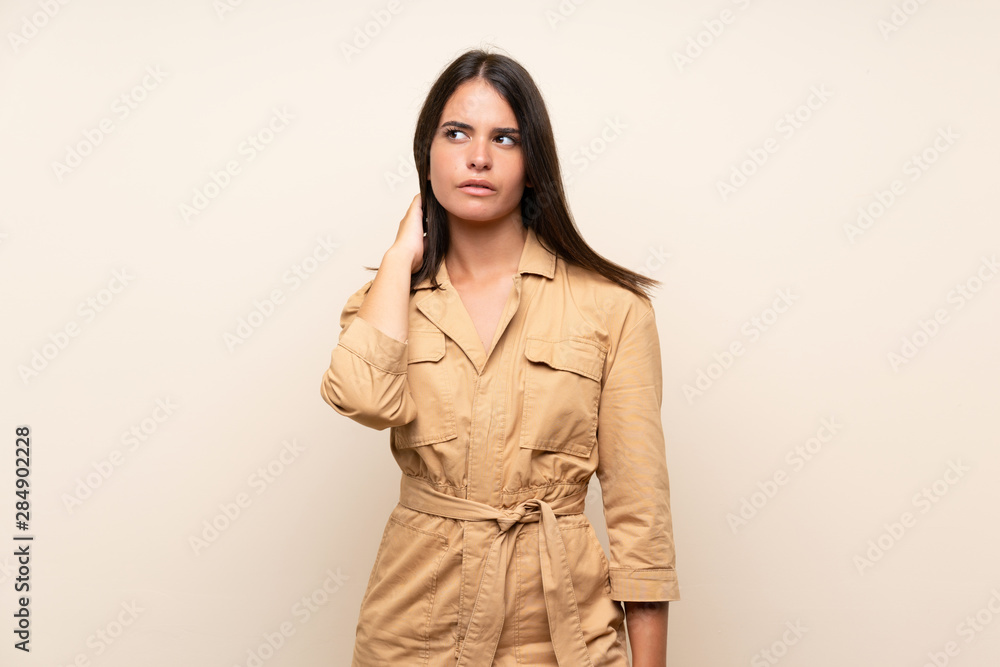 Young girl over isolated background having doubts Young girl over isolated background having doubts