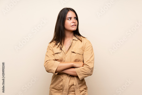 Young girl over isolated background with confuse face expression