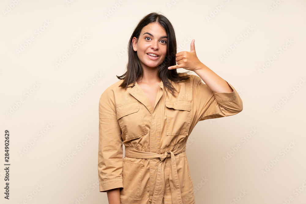Young girl over isolated background making phone gesture. Call me back sign Young girl over isolated background making phone gesture. Call me back sign
