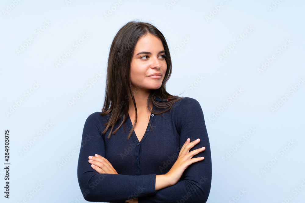 Young girl over isolated blue background thinking an idea Young girl over isolated blue background thinking an idea