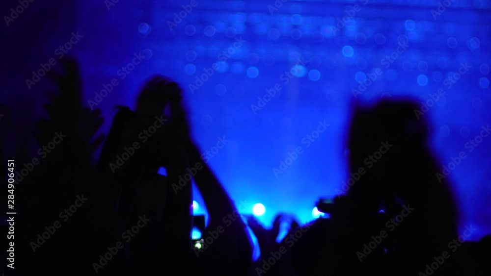 Abstract hands up in the air applauding. Out of focus stage lights in the background Abstract hands up in the air applauding. Out of focus stage lights in the background