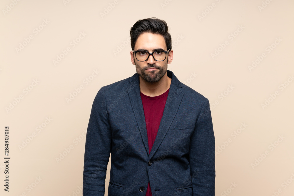 Handsome young man over isolated background with sad and depressed expression Handsome young man over isolated background with sad and depressed expression