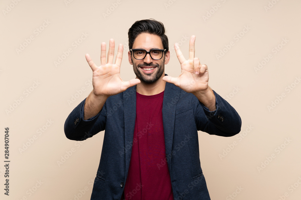 Handsome young man over isolated background counting eight with fingers