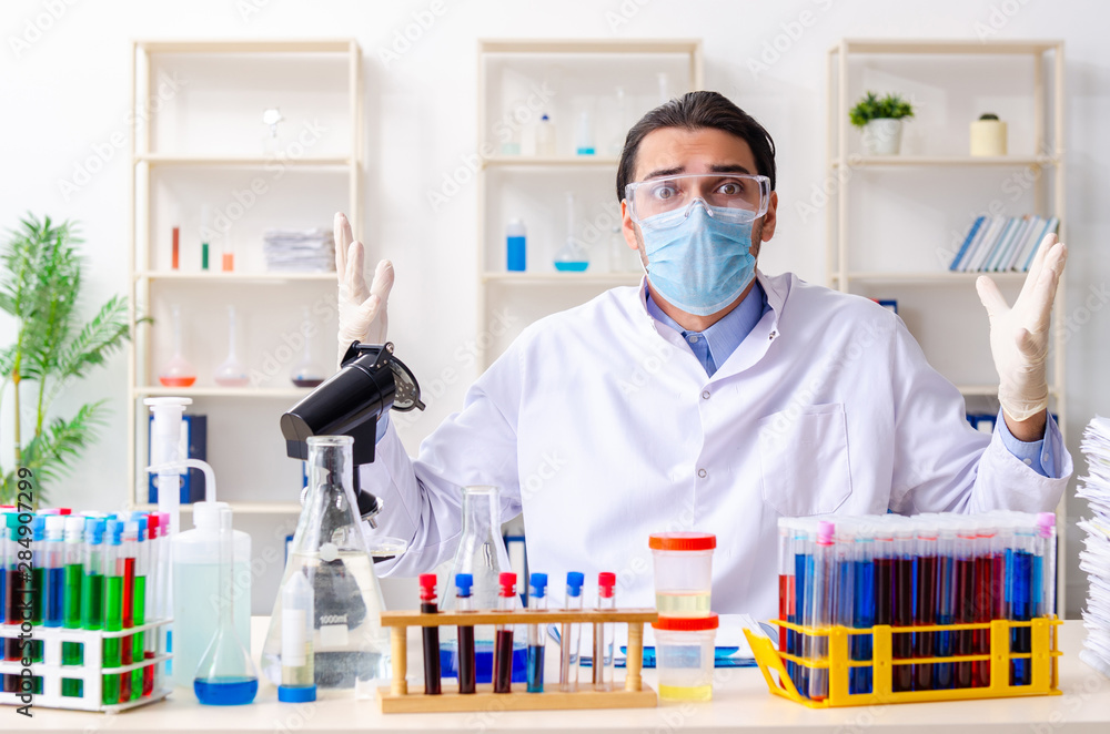 Young male chemist working in the lab Young male chemist working in the lab