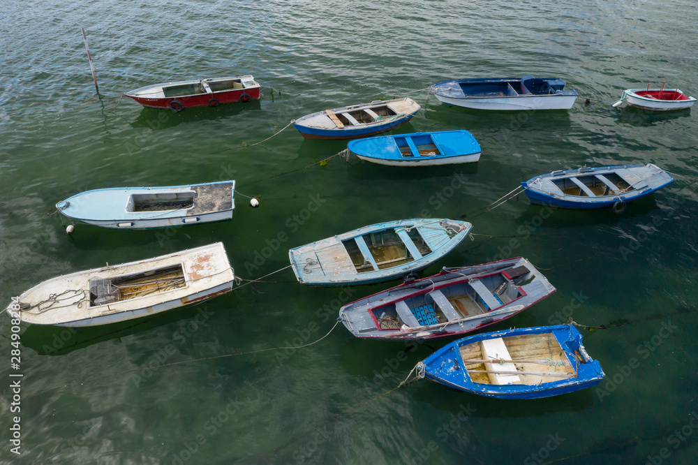 wooden fishing boats anchored in the sea, top view