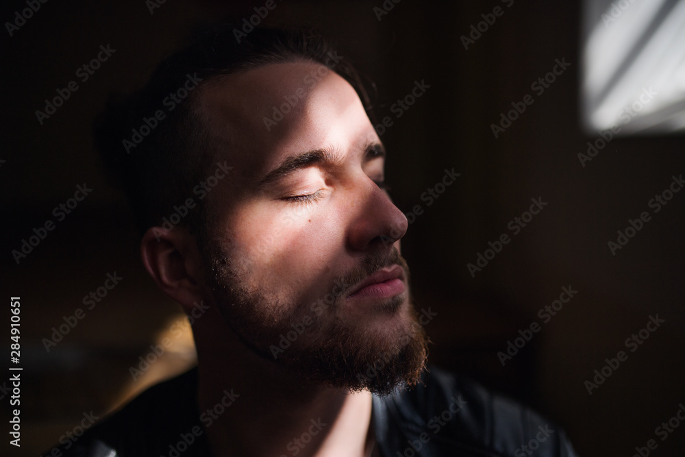 A portrait of young man indoors, a close-up. A portrait of young man indoors, a close-up.