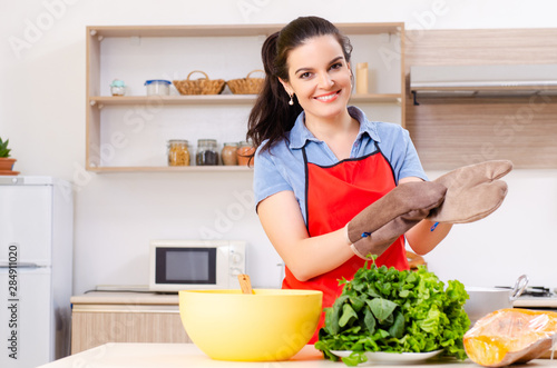 Young woman with vegetables in the kitchen