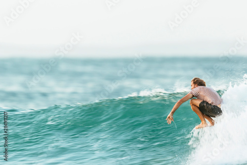 A man is surfing on the nose of a longboard at Tea Tree Bay, Noosa National Park, Queensland, Australia photo