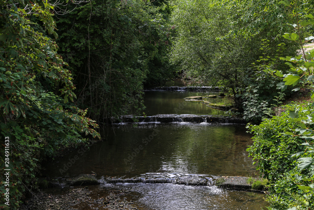 River flowing in a cascade of artificial waterfalls River flowing in a cascade of artificial waterfalls