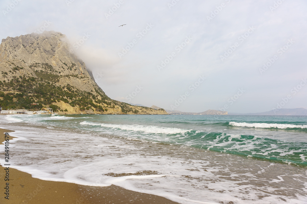 Turquoise Black sea cold spring day in the village of Novy Svet, Crimea. The moon Turquoise Black sea cold spring day in the village of Novy Svet, Crimea. The moon