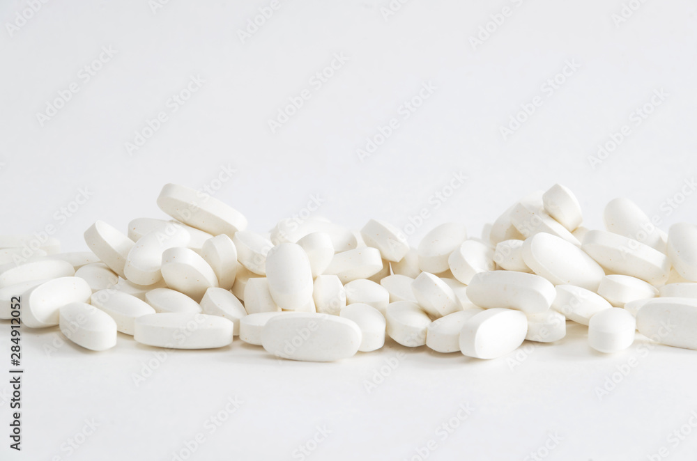 Group of white magnesium pills on white backgrond Group of white magnesium pills on white backgrond