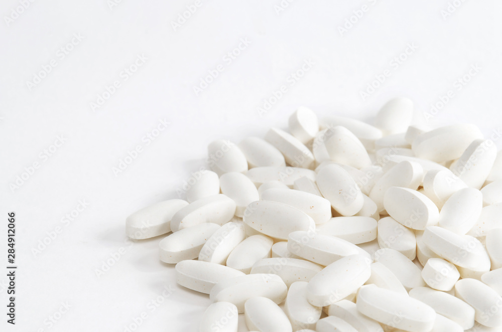 Group of white vitamin pills on white backgrond Group of white vitamin pills on white backgrond