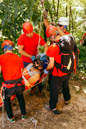 Search and rescue team helping injured bicyclist