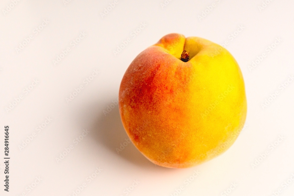 Ripe peach close-up on a white table Ripe peach close-up on a white table
