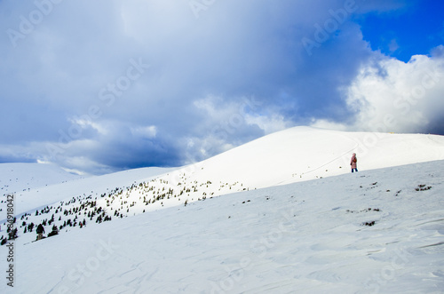 People climbing in Carpathian mountains in winter, covered with snow
