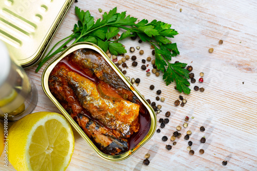 Open can of sardines on table photo