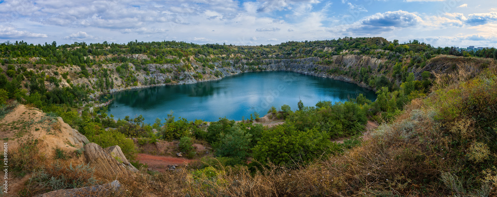 Lake in an abandoned quarry. Panorama. Top view.