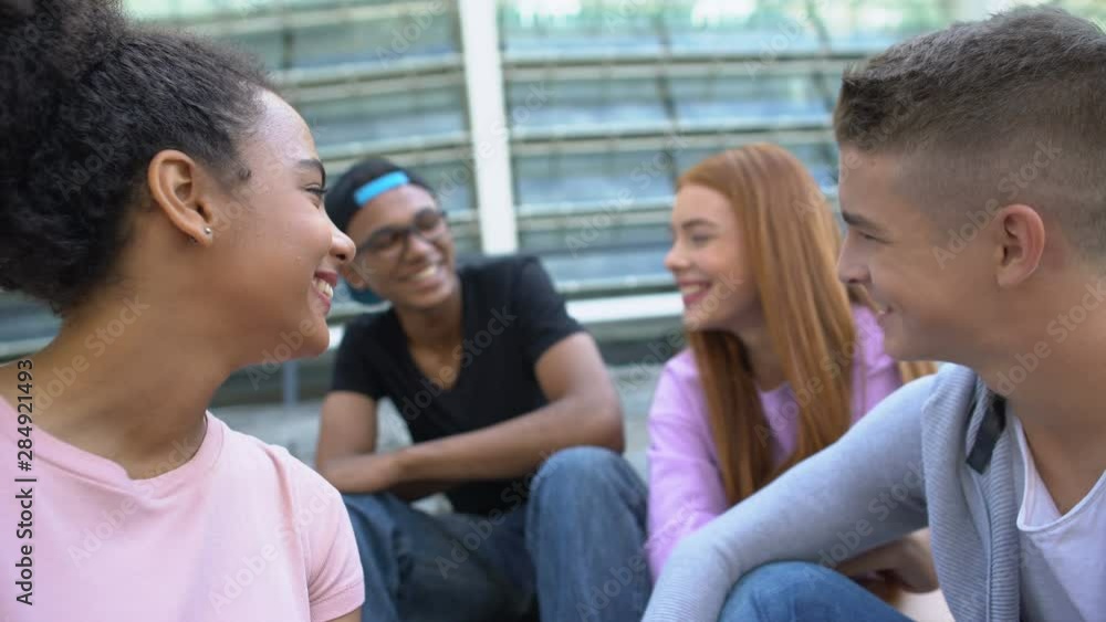 Young carefree mixed-race friends laughing and having fun outdoors, summer relax Young carefree mixed-race friends laughing and having fun outdoors, summer relax