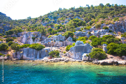 The ruins of an ancient city by the sea. The city was built by the ancient Romans. The city is located in modern Turkey on the shores of the Mediterranean Sea.