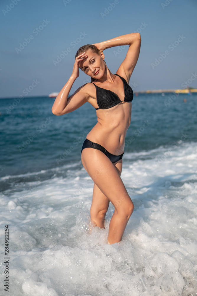 Fine in a reservoir on a weightless mattress similar on a pizza in a red bathing suit