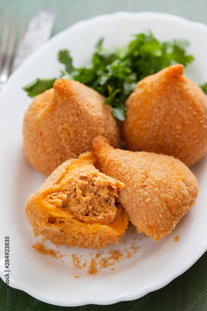 coxinha de frango, typical brazilian chicken croquette on white dish coxinha de frango, typical brazilian chicken croquette on white dish
