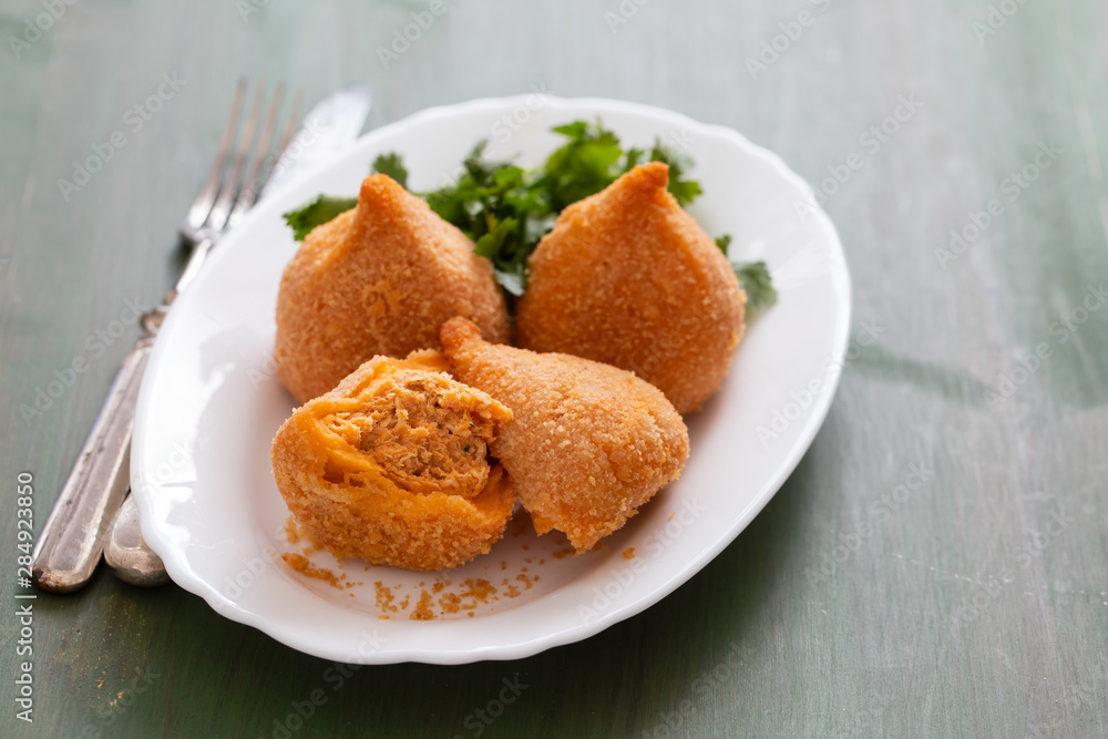 coxinha de frango, typical brazilian chicken croquette on white dish coxinha de frango, typical brazilian chicken croquette on white dish