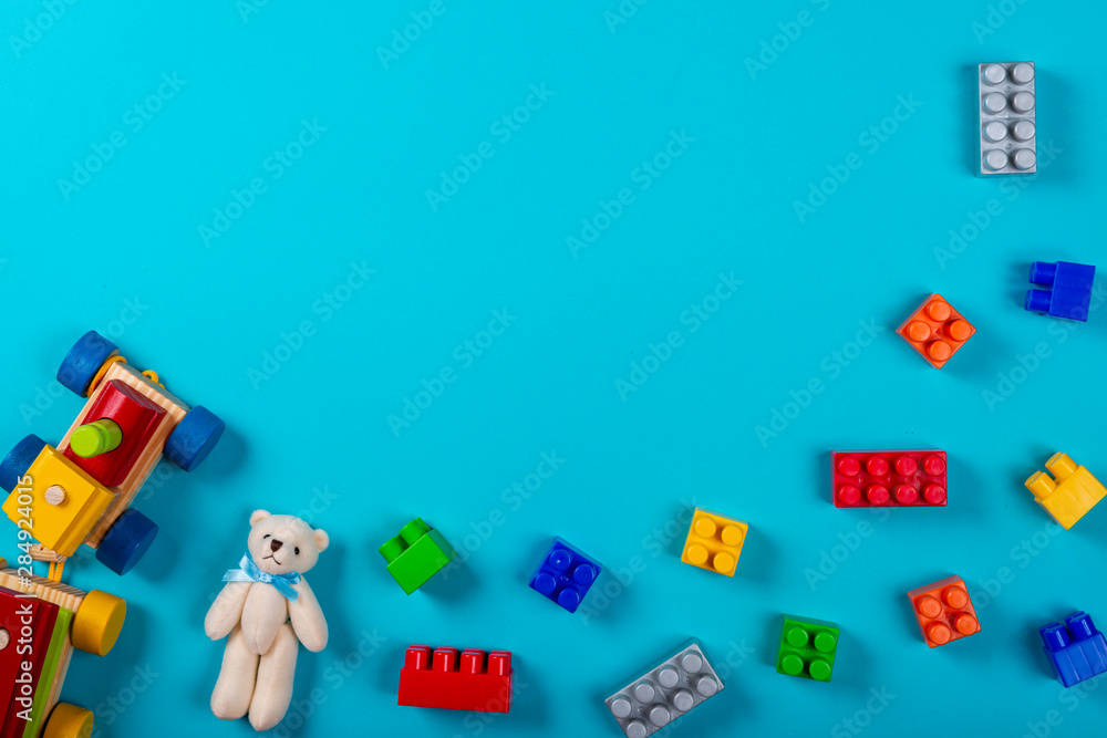 Various children's toys on blue background. Space for text in the center of the image. Various children's toys on blue background. Space for text in the center of the image.