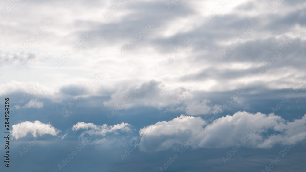 gloomy clouds with a gleam of the sun passing into the clear sky gloomy clouds with a gleam of the sun passing into the clear sky