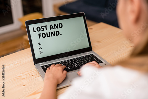Conceptual hand writing showing Lost And Found. Concept meaning a place where lost items are stored until they reclaimed woman with laptop smartphone and office supplies technology