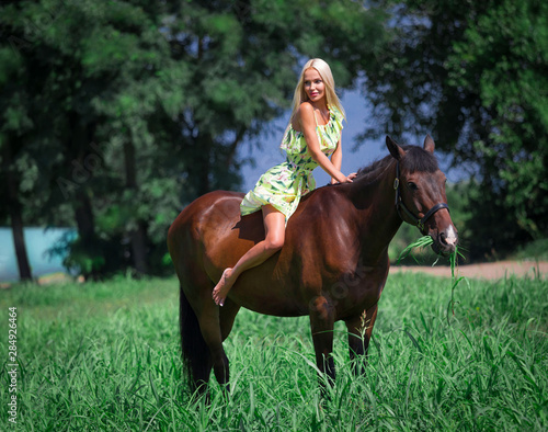 Woman and horse, green field, yellow dress © erainbow