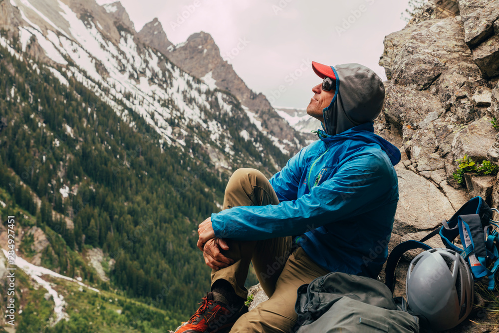 © Tandem Stock - A man relaxes at the base of 'Guides Wall' on a stormy day, Cascade Canyon, Grand Teton National Park, Wyoming, USA © Tandem Stock - A man relaxes at the base of 'Guides Wall' on a stormy day, Cascade Canyon, Grand Teton National Park, Wyoming, USA