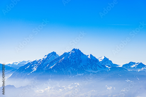 Majestic unique misty blue alpine skyline view panorama of Mount Pilatus and blue sky, Lucerne, Switzerland.
