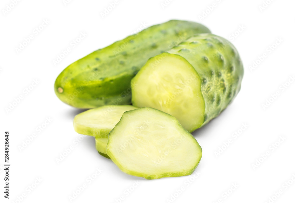 Whole cucumber with cutted cucumber on white. Whole cucumber with cutted cucumber on white.