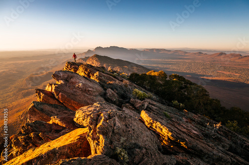 Canvas Print Woman walking on cliff at St Mary Peak during sunrise, Australia