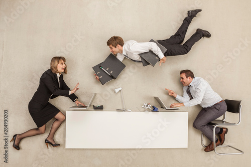 Business people working while another businessman providing files photo