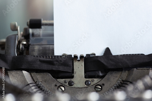 Old typewriter and a blank paper page with a copy space.