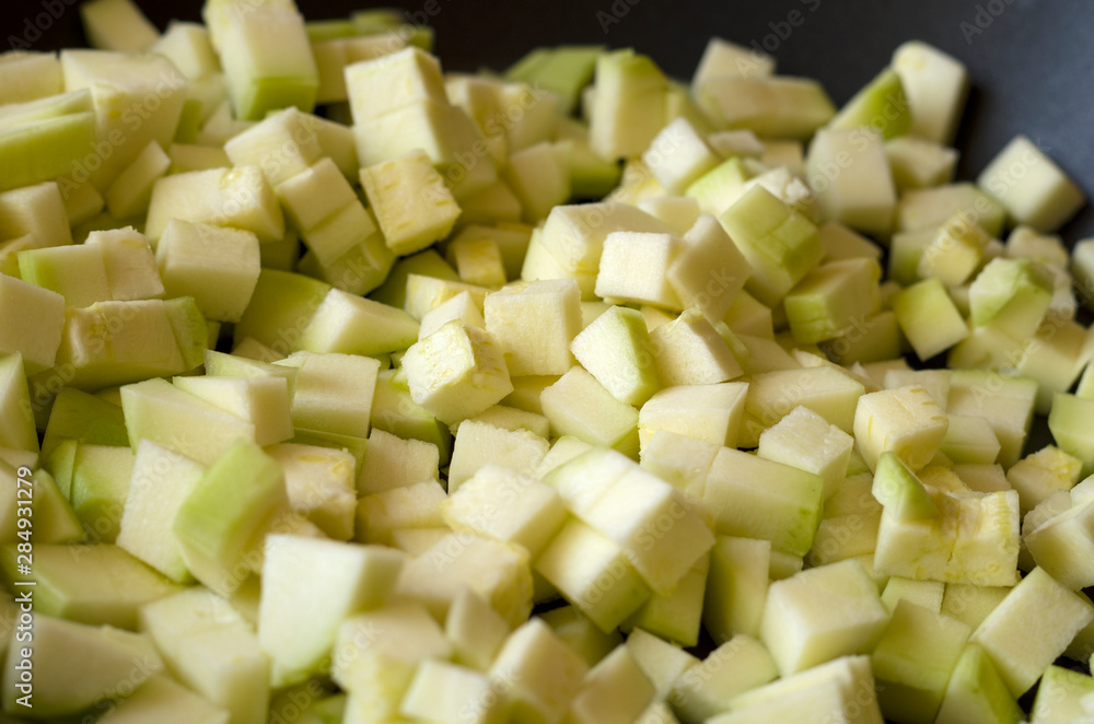 light green diced zucchini, close up view light green diced zucchini, close up view